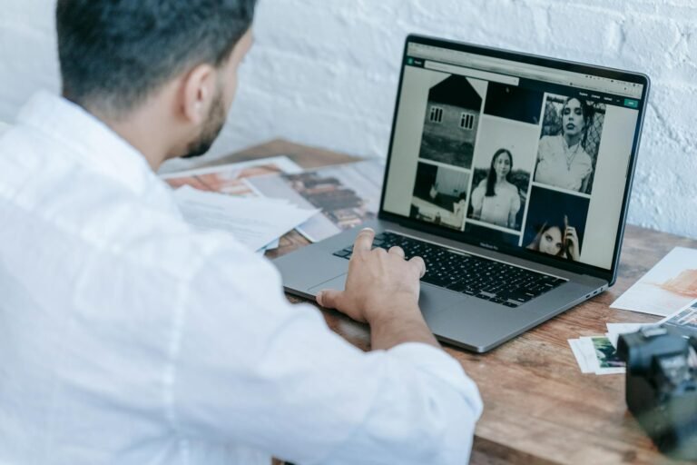 man editing photos on laptop