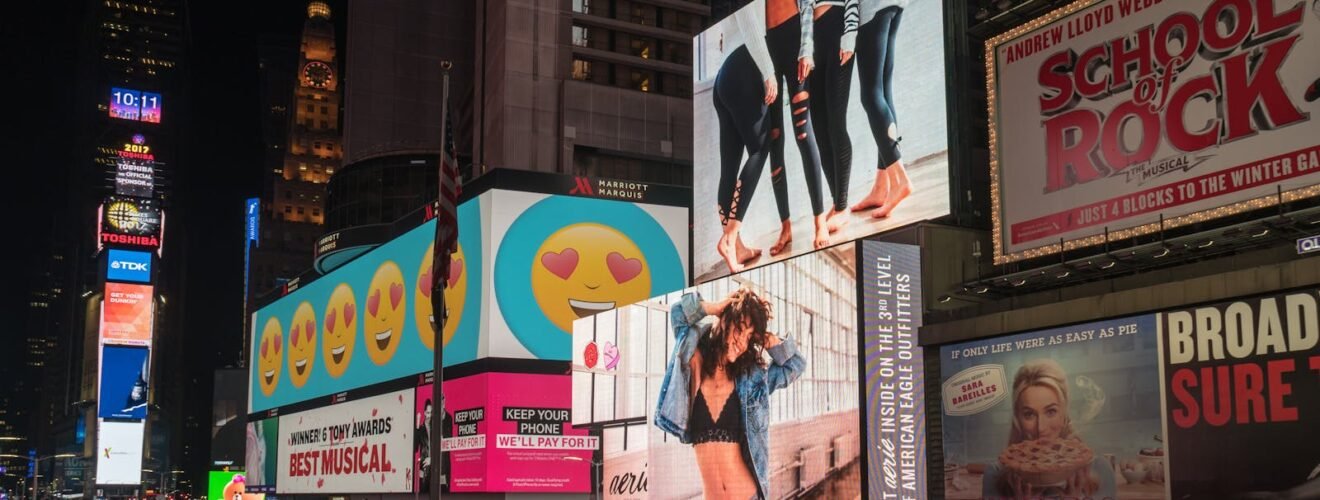 Colorful billboards light up New York City's iconic Times Square at night, with vibrant ads and bustling crowds.