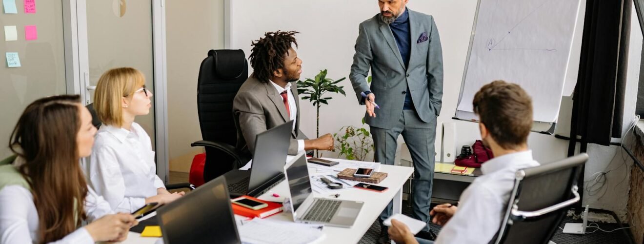 Corporate team in a modern office, engaged in a discussion with diverse colleagues.