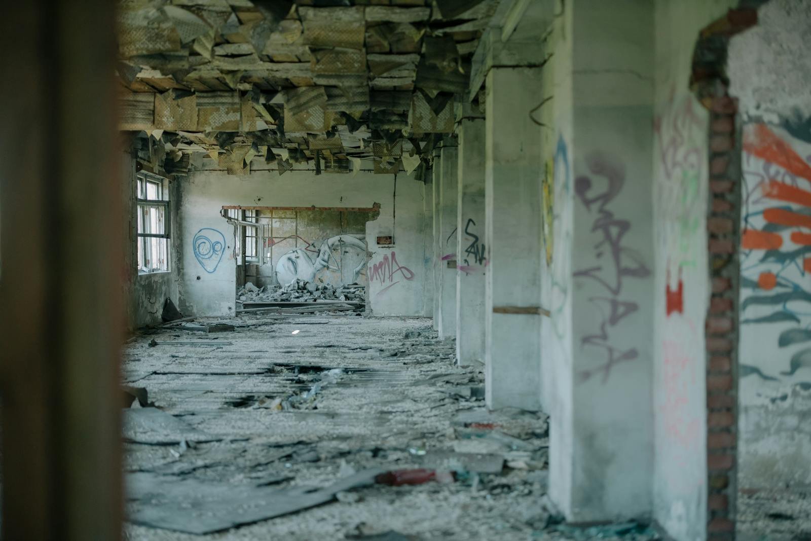 An abandoned building interior with graffiti, showcasing decay and urban desolation.