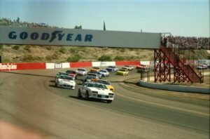 High-speed NASCAR race cars navigating a turn during a thrilling race at Avondale track.