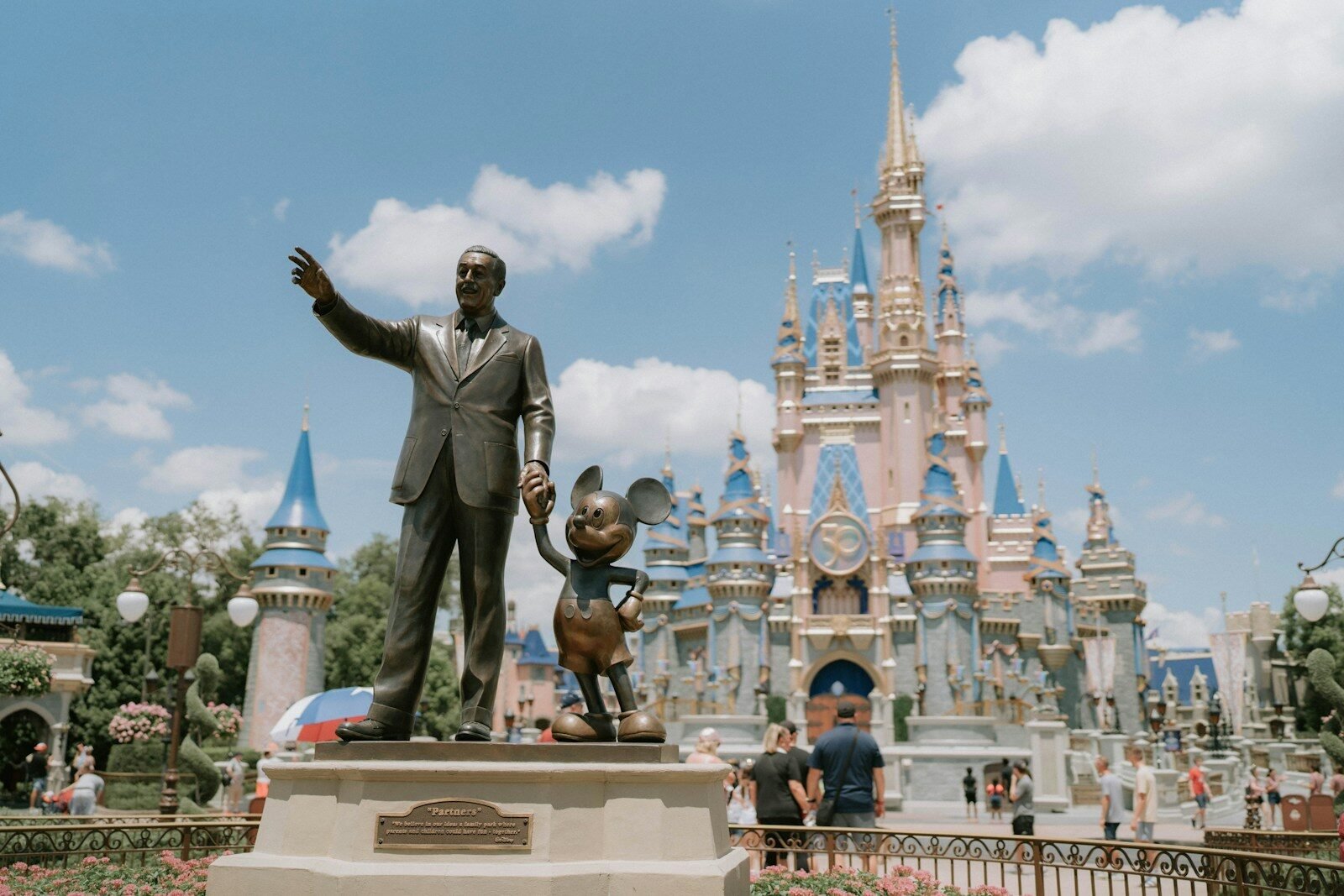 a statue of a man in front of a castle